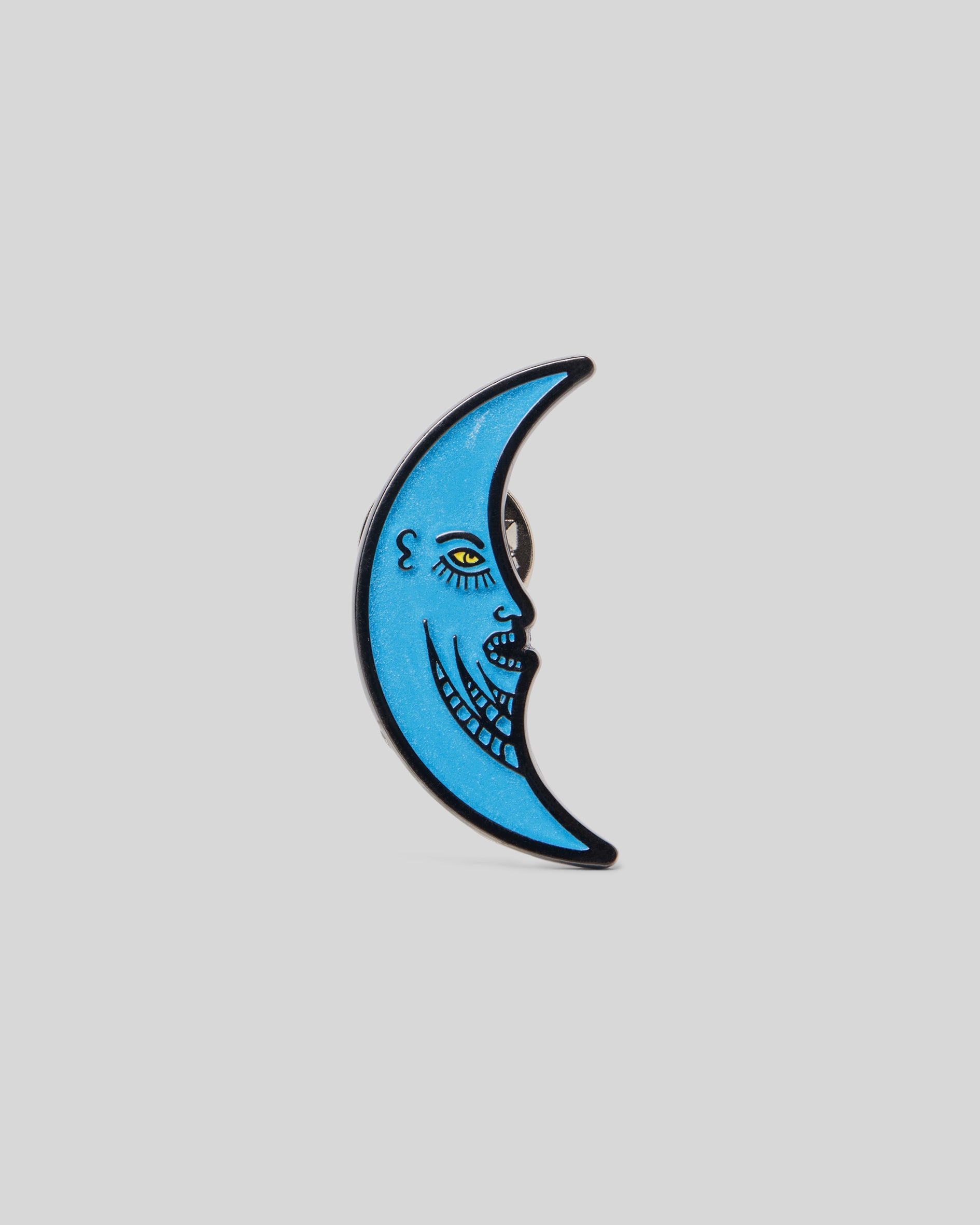 1987 Half Moon Pin. Blue metal half moon face pin.
