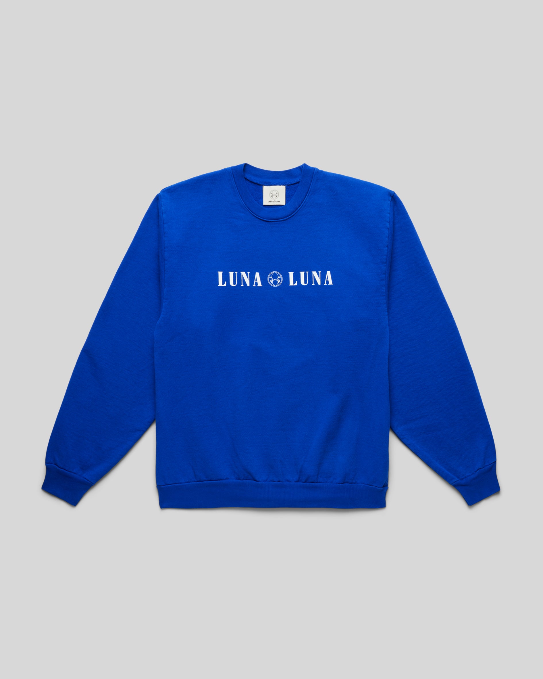 Flat front photo of the 1987 Logo Crewneck, cobalt blue sweatshirt with Luna Luna logo