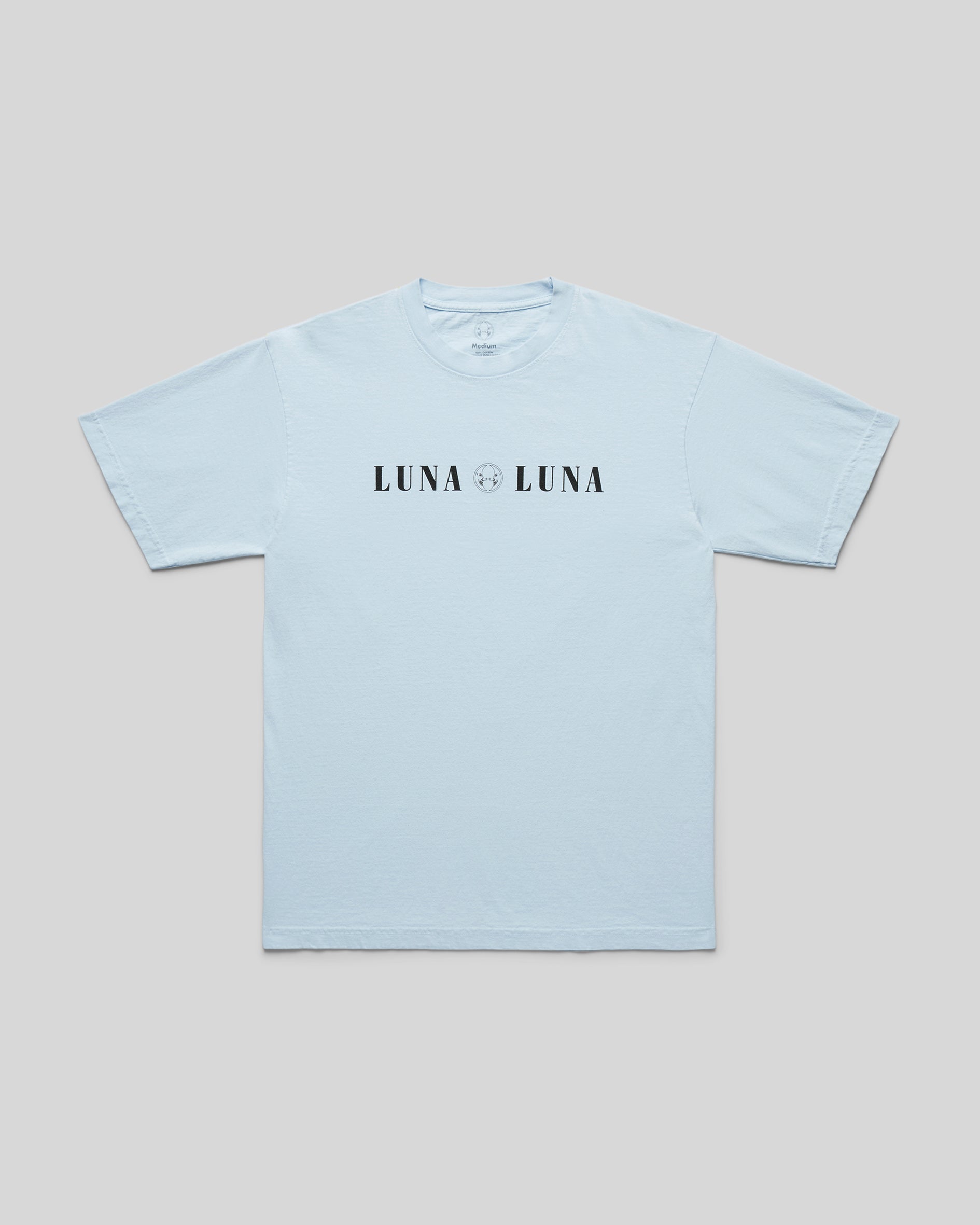 1987 Luna Luna T-Shirt in Baby Blue. Baby blue t-shirt with black text at chest that reads "LUNA LUNA"